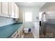 Functional laundry room with ample counter space, storage cabinets, and modern appliances at 1717 Deer Run Rd, Catawba, SC 29704