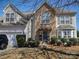 Charming two-story home with stone accents, well-manicured shrubs, and an attached two-car garage at 1912 Darbywine Dr, Charlotte, NC 28216