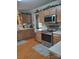 Well-lit kitchen featuring wood cabinets, modern appliances, and durable floors at 1912 Darbywine Dr, Charlotte, NC 28216