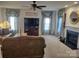 Cozy living room featuring a fireplace, ceiling fan, and neutral carpet at 1912 Darbywine Dr, Charlotte, NC 28216