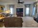 Bright living room with a fireplace, ceiling fan, and comfortable seating at 1912 Darbywine Dr, Charlotte, NC 28216