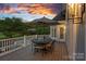 Inviting outdoor deck with dining set, perfect for enjoying serene views and outdoor meals at sunset at 19216 Peninsula Shores Dr, Cornelius, NC 28031
