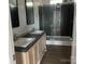 Bathroom featuring double sinks, dark gray counters, and glass shower at 2070 Travis Rd, Conover, NC 28613