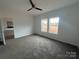 Bright bedroom with plush carpeting, two windows and a modern ceiling fan at 2070 Travis Rd, Conover, NC 28613