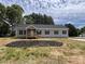 Charming single-story home with a covered porch, black shutters, and a newly landscaped yard at 2070 Travis Rd, Conover, NC 28613