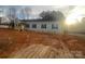Charming single-story home with gray siding, black shutters, and a newly built wooden porch in a sunny neighborhood at 2070 Travis Rd, Conover, NC 28613