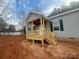 Newly constructed wooden front porch with steps leading to the entrance of this cozy gray home at 2070 Travis Rd, Conover, NC 28613