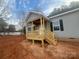 New front porch with wooden railings and gray siding at 2070 Travis Rd, Conover, NC 28613