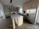 Modern kitchen with stainless steel appliances, light wood cabinets, and a center island with stone countertop at 2070 Travis Rd, Conover, NC 28613