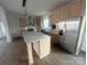 Kitchen with stainless steel appliances, island, and light wood cabinets at 2070 Travis Rd, Conover, NC 28613