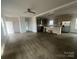 A combined living room and kitchen with dark wood floors, recessed lights, and an eat-in island at 2070 Travis Rd, Conover, NC 28613