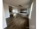 Open-concept living area with hardwood floors, TV wall mount, and an eat-in kitchen island at 2070 Travis Rd, Conover, NC 28613