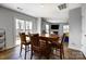 Inviting dining area features a wooden table and a sliding glass door leading to the outdoors and a view of the living room at 2135 Eastway Dr, Dallas, NC 28034