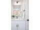 Bright half-bathroom with white countertops, stylish modern fixtures, and natural lighting at 2544 Pinestream Dr, Charlotte, NC 28216