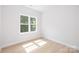 Bright, empty bedroom featuring hardwood floors and a window for natural light at 2544 Pinestream Dr, Charlotte, NC 28216