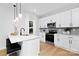 Bright and airy kitchen with white cabinets, a modern island, and stainless steel appliances for a contemporary feel at 2544 Pinestream Dr, Charlotte, NC 28216