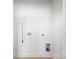 A minimalistic laundry room with hookups, shelf, and freshly-painted white walls at 2544 Pinestream Dr, Charlotte, NC 28216