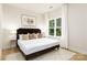 Serene bedroom with a plush bed, stylish decor, and a large window offering natural light and a peaceful ambiance at 2544 Pinestream Dr, Charlotte, NC 28216