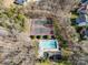 Aerial view showcasing a community pool, clubhouse, and tennis courts surrounded by trees and landscaping at 2604 Lamplighter Dr, Kannapolis, NC 28081