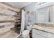 A bathroom featuring stylish shower with pebble floor, wood-look tile and a vanity with granite countertop at 2604 Lamplighter Dr, Kannapolis, NC 28081