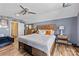 A modern bedroom featuring a wood-look flooring, a ceiling fan, a comfortable bed, and a large dresser at 2604 Lamplighter Dr, Kannapolis, NC 28081