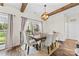 Cozy dining area with exposed wood beam, stylish light fixture, and backyard view at 2604 Lamplighter Dr, Kannapolis, NC 28081