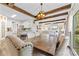 Open concept dining area with wood beams, decorative lighting, and views of the living spaces at 2604 Lamplighter Dr, Kannapolis, NC 28081