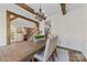 A dining room featuring wooden beams, chandelier, dining table with chairs, and staircase with a kitchen view at 2604 Lamplighter Dr, Kannapolis, NC 28081