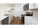 Modern kitchen with stainless steel appliances, quartz countertops, and white cabinetry at 3044 Ora Smith Rd, Lincolnton, NC 28092