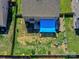 Aerial view of a fenced backyard featuring a blue sunshade, patio with outdoor seating, and play equipment at 3426 Dominion Green Dr, Charlotte, NC 28269