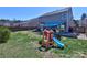 A spacious fenced backyard with a play set and a covered seating area is an ideal space for recreation at 3426 Dominion Green Dr, Charlotte, NC 28269