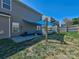 A backyard features outdoor seating with sun shade, green grass, and a partial view of the home at 3426 Dominion Green Dr, Charlotte, NC 28269