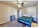 A carpeted bedroom features a ceiling fan, dresser, bed, and open doorway to the next level at 3426 Dominion Green Dr, Charlotte, NC 28269