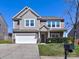 Charming two-story home featuring a two-car garage, manicured lawn, and lovely landscaping for great curb appeal at 3426 Dominion Green Dr, Charlotte, NC 28269