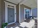 Inviting front porch with seating area and stylish front door with sidelight at 3426 Dominion Green Dr, Charlotte, NC 28269