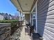 Comfortable front porch featuring stone columns, wicker seating, and ample natural light at 3426 Dominion Green Dr, Charlotte, NC 28269