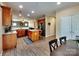 Well-lit kitchen with granite countertops, wood cabinets, and island flows into the living area, ideal for gatherings at 3426 Dominion Green Dr, Charlotte, NC 28269