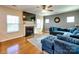 Cozy living room with hardwood floors, fireplace, and a comfortable blue sectional sofa, perfect for relaxation at 3426 Dominion Green Dr, Charlotte, NC 28269