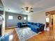 Bright living room with hardwood floors, comfortable blue sectional sofa, and a fireplace creating a welcoming atmosphere at 3426 Dominion Green Dr, Charlotte, NC 28269