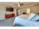 Spacious bedroom with ceiling fan, television and three doors at 3426 Dominion Green Dr, Charlotte, NC 28269