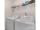 Functional laundry area featuring white appliances and overhead storage shelf with laundry supplies at 353 Webb Farm Rd, Shelby, NC 28152