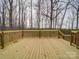 A spacious wooden deck perfect for outdoor entertaining with railings and a private backyard view at 40701 Nc 740 Hwy, New London, NC 28127