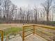 Spacious backyard view from the wooden deck, surrounded by a serene wooded area with mature trees at 40701 Nc 740 Hwy, New London, NC 28127