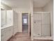 Well-lit bathroom featuring wood-look flooring, a double sink vanity, and glass enclosed shower at 40701 Nc 740 Hwy, New London, NC 28127