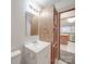 Bathroom features white vanity and wood grain storage cabinet with a view of the kitchen at 40701 Nc 740 Hwy, New London, NC 28127