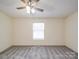 Bedroom features neutral walls, plush carpet, ceiling fan and a window for natural light at 40701 Nc 740 Hwy, New London, NC 28127