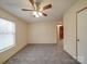 Bedroom features neutral walls, plush carpet, ceiling fan and a window for natural light at 40701 Nc 740 Hwy, New London, NC 28127