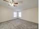 A bedroom featuring neutral walls, carpeted floors, and natural light from the windows at 40701 Nc 740 Hwy, New London, NC 28127