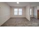 Versatile room with neutral walls and carpet, featuring two large windows for plenty of natural light at 40701 Nc 740 Hwy, New London, NC 28127