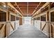A rustic barn interior featuring wooden stalls and a concrete floor, providing a functional and charming equestrian facility at 447 Willow Pond Ln, Hiddenite, NC 28636
